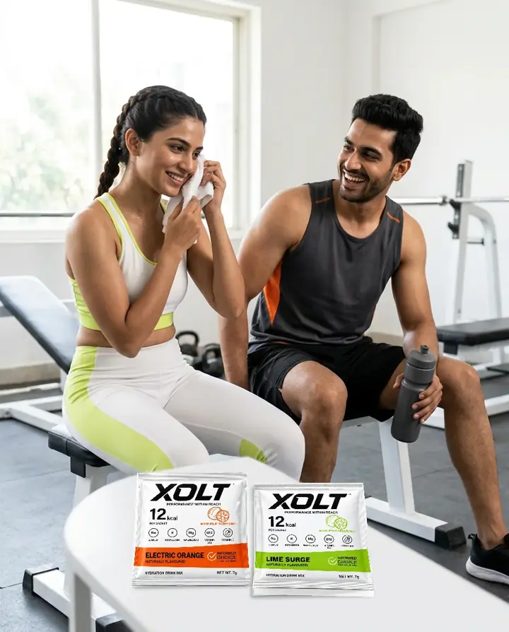 An Indian woman and man relaxing after training with XOLT at the gym